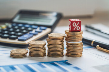 Stacked Coins with Percentage Symbol on Financial Report