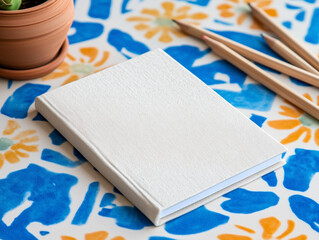  A textured white notebook with a minimal design, lying on a vibrant, retro-style background...