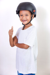 A cheerful asian boy in a helmet gives a thumbs up, showing his excitement for safety.