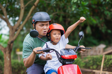 A joyful asian father and son ride a electric scooter, sharing excitement and adventure together.