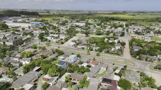 Drone orbits neighborhood on Uruguay side of Chuy near windmills