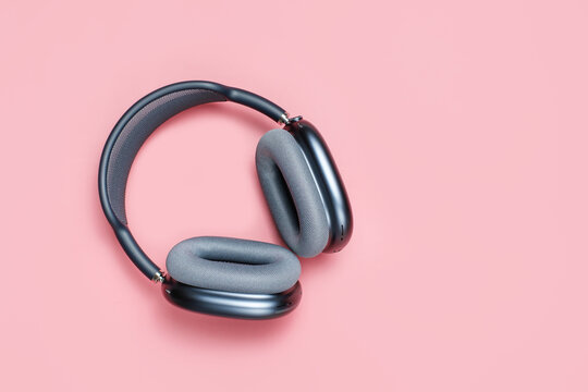 Seoul - 19.12.2024: AirPods Max on pink background close-up, top view.