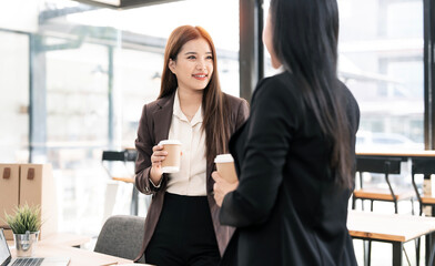 Two young colleagues reviewing business reports during break