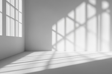 Obraz premium Sunlight casts window shadows on a minimalist white room corner.
