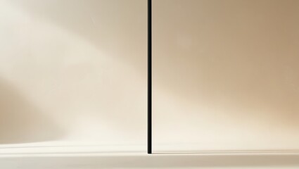 Minimalist Black Pole Against Beige Wall Background