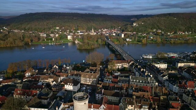 Vernon cityscape with Pont Clemenceau bridge crossing Seine river, Normandy in France. Aerial backward