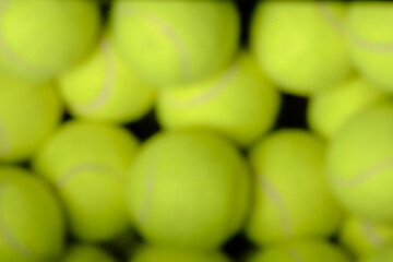 Defocused or blur image of green tennis balls for sport background
