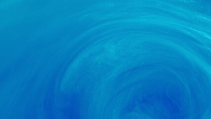 Sparkling flow. Mixing paint. Defocused bright blue splash ink mist vortex smoke cloud fluid moving...