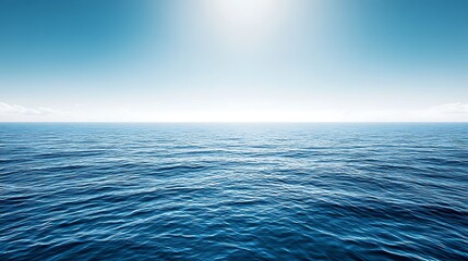 Fototapeta premium Calm ocean surface under a bright sunlit sky.