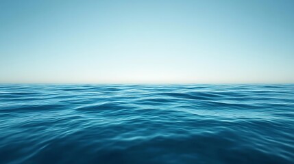 Obraz premium Calm ocean surface with a clear blue sky.