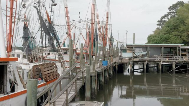 Close up aerial dolly shot of the rigging on a shrimp boat in South Carolina.
