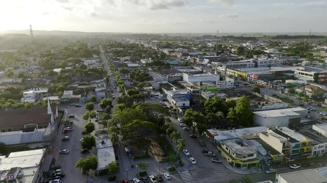 Drone orbits east and north side of square facing the sunset in Chuy