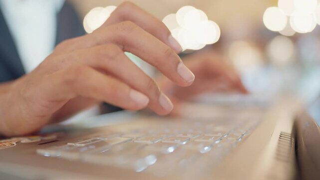 A person is typing on a keyboard with their hand on the space bar. Concept of focus and concentration as the person types