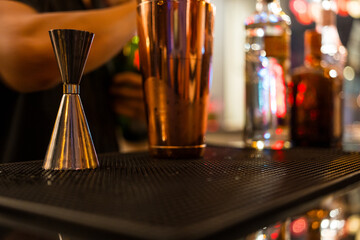 Barman preparing cocktail for celebrating holiday party at restaurant bar.