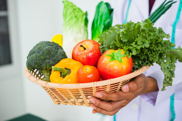 A male doctor advises consuming organic vegetables and fruits, emphasizing their nutritional value, vitamins, and minerals from chemical-free gardens for optimal health and overall well-being.