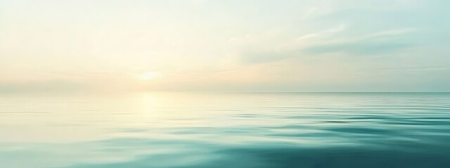 Obraz premium Serene seascape at sunrise, blurred for dreamy effect.