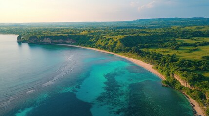 Fototapeta premium Aerial view of secluded tropical beach with turquoise water and lush green cliffs.