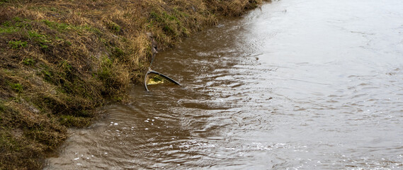 Sinking rowing boat in swollen river