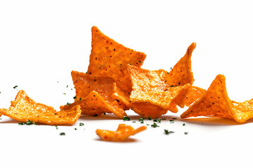 Naklejka premium Crunchy orange snack chips scattered on a white background showcasing texture and color contrast