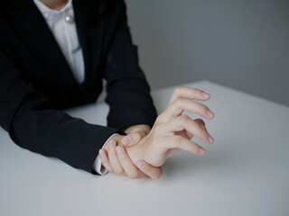 Young Asian woman feels numbness and severe pain in her wrist Caused by sitting and working for a...