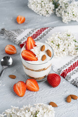 Ricotta dessert with fresh strawberries. Healthy breakfast of yogurt, strawberry and almonds
