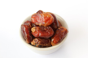 Kurma dried date palm fruits, Ramadan food which eaten in fasting month for Muslim. Pile of fresh dried date fruits in a bowl.