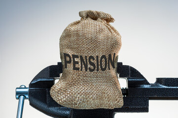 Compressing pension. Money bag with pension in vise.