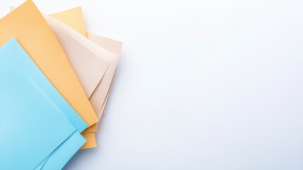A collection of colorful paper sheets arranged on a light background, showcasing various pastel hues for creative or organizational purposes.