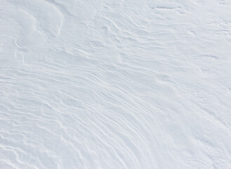 The snow is white and has a wavy texture
