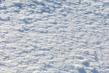 The snow is white and the ground is covered in it