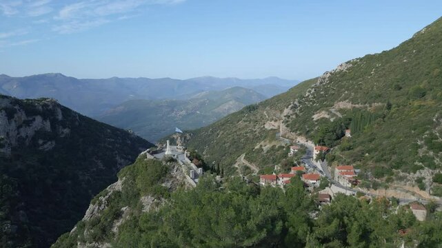 An aerial view of the World War II monument in Stemnitsa village, surrounded by a green background of trees