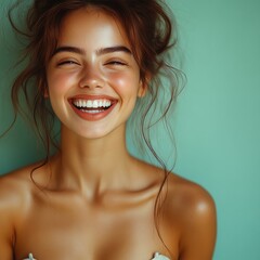 Obraz premium A woman with a big smile on her face is wearing a bikini top