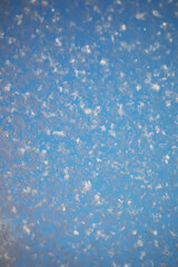 Macro Snowflakes Against Blue Sky: Winter Texture and Pattern Close-Up in Nature Photography