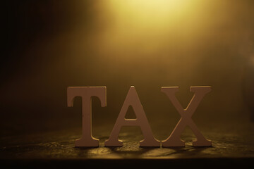 Golden Tax Concept with Wooden Letters Symbolizing Financial Obligations and Government Levies