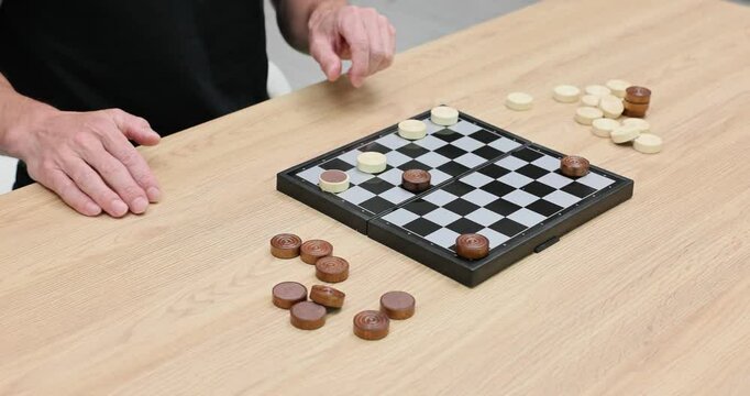 Player makes strategic move in game of checkers