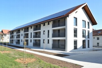 Modern Apartment Building with Solar Panels and Green Surroundings, Featuring Bright Facade and Spacious Balconies in a Sunny Residential Area