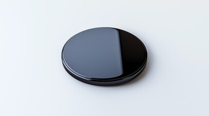 A sleek, circular black object with a glossy finish, reflecting light on one side, set against a plain background.
