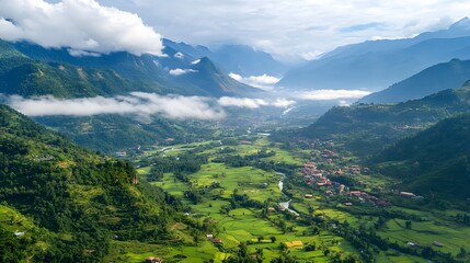 Fototapeta premium Breathtaking aerial view of lush green valley surrounded by majestic mountains.