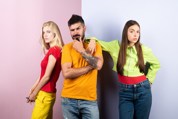 Group of friends posing in studio. Group of tree People. Friends face. Three young people portrait. Great team. Group of three cheerful young people in casual wear looking at camera.