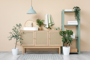 Interior of bathroom with sink, towels and shelf unit