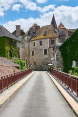 View at the medieval village of Carennac in Lot Occitanie Southern France from the bridge under a blue sky with clouds in summer. Image withe copy space