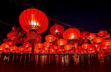 Chinese red lanterns on the night of the happy Chinese New Year decorate the streets.