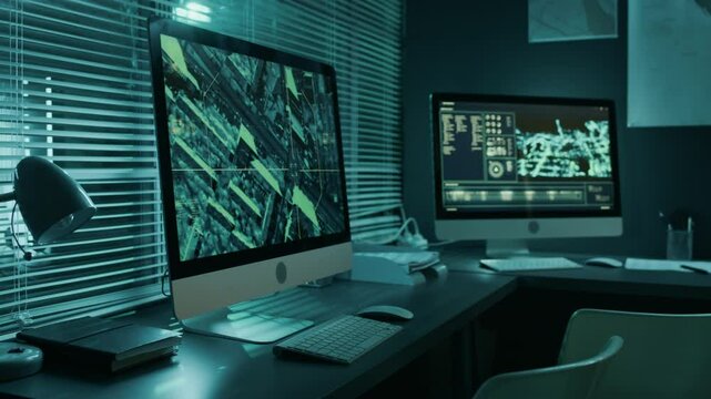 Medium side shot of computer on desk at investigation bureau or military command center. Satellite surveillance software zooming in on city street while scanning urban area for suspicious activity