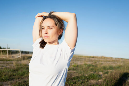woman stretching outside in the sunshine