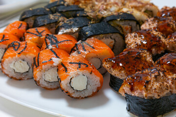 Japanese Cuisine. Macroshot of Two Traditional Sushi Rolls With Salmon, Ginger and Orange Together on White