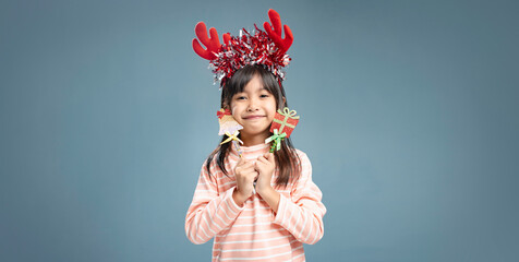 A little girl is happy to join the Christmas day.