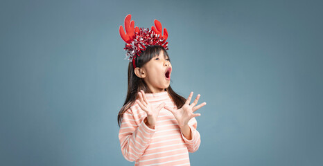 A little girl is happy to join the Christmas day.