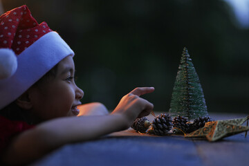A little girl is happy to join the christmas day.