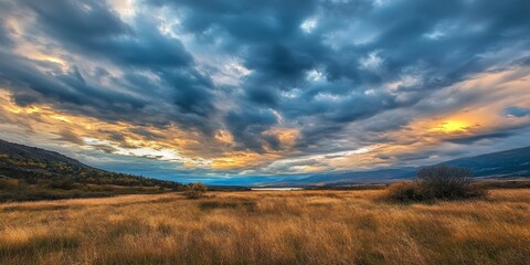 Obraz premium Dramatic cloudy sky showcasing the beauty of nature, highlighting the unique atmospheric conditions found in a stunning landscape with a captivating cloudy sky. Experience the allure of a cloudy sky.
