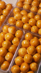 Nastar cookies with pineapple jam and glossy orange egg yolk spread, arranged in a plastic jar. is one of the traditional Indonesian cookies served during the celebration of Eid al-Fitr.